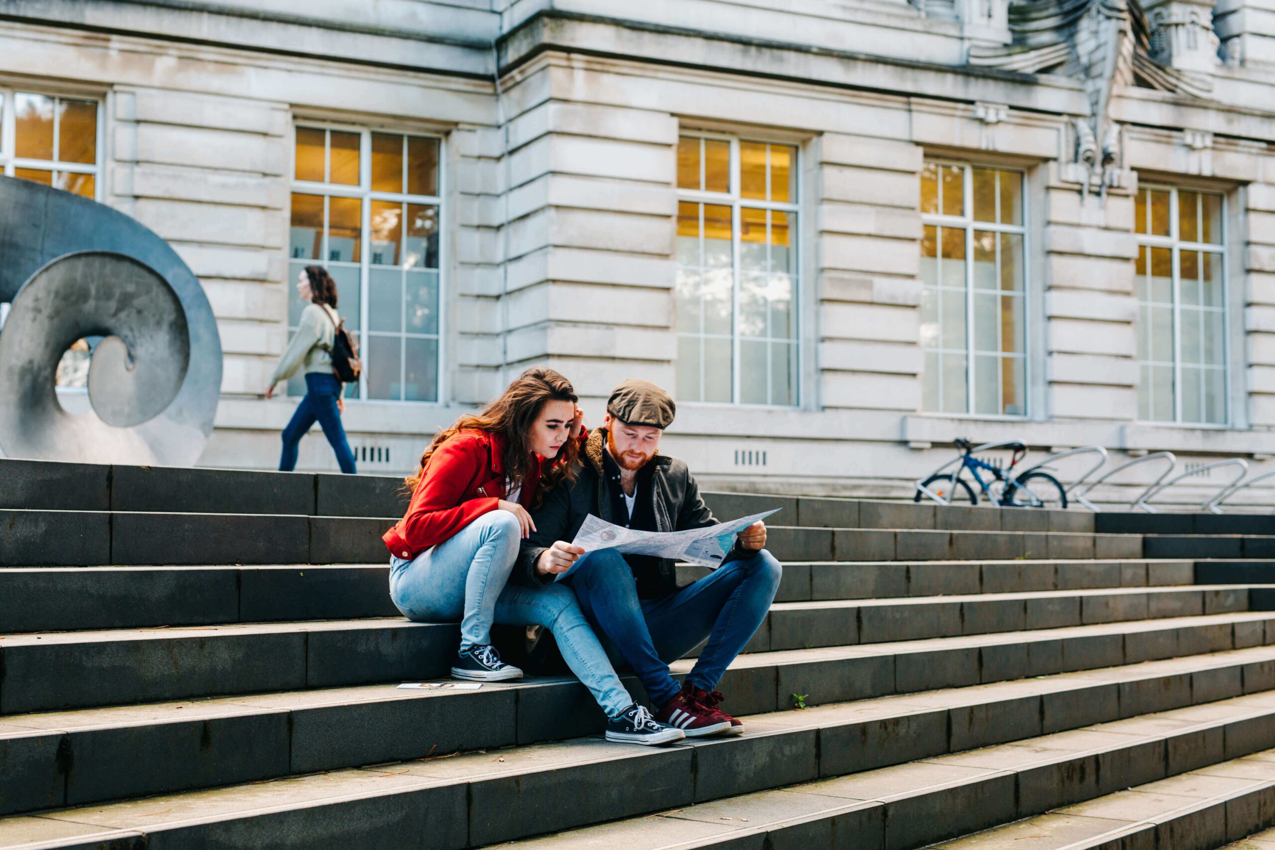 Couple reading a map on steps