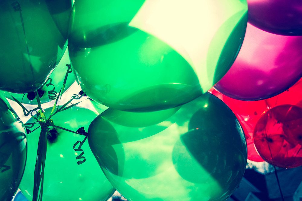 Red and green balloons with sunlight