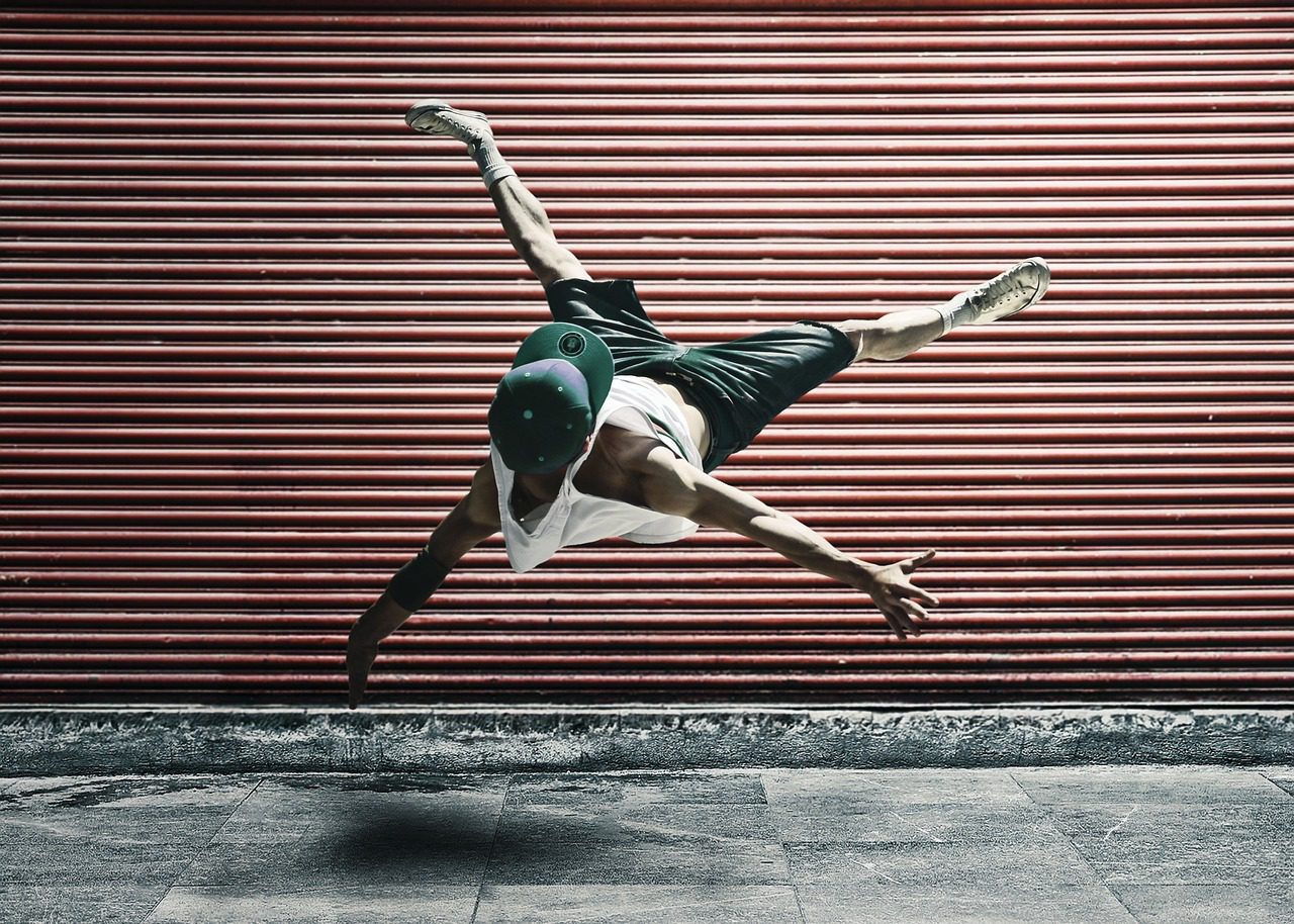 Dancer jumping in front of a shop shutter