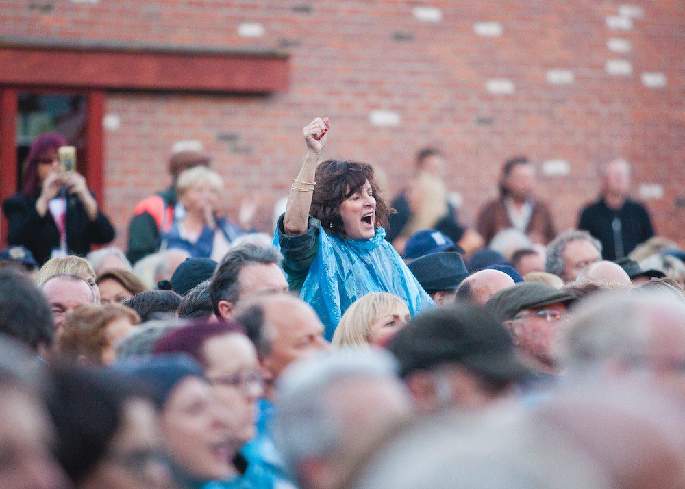 Woman cheering at an outdoor festival