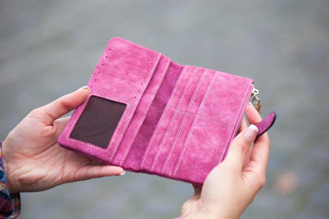 Woman holding a open pink wallet