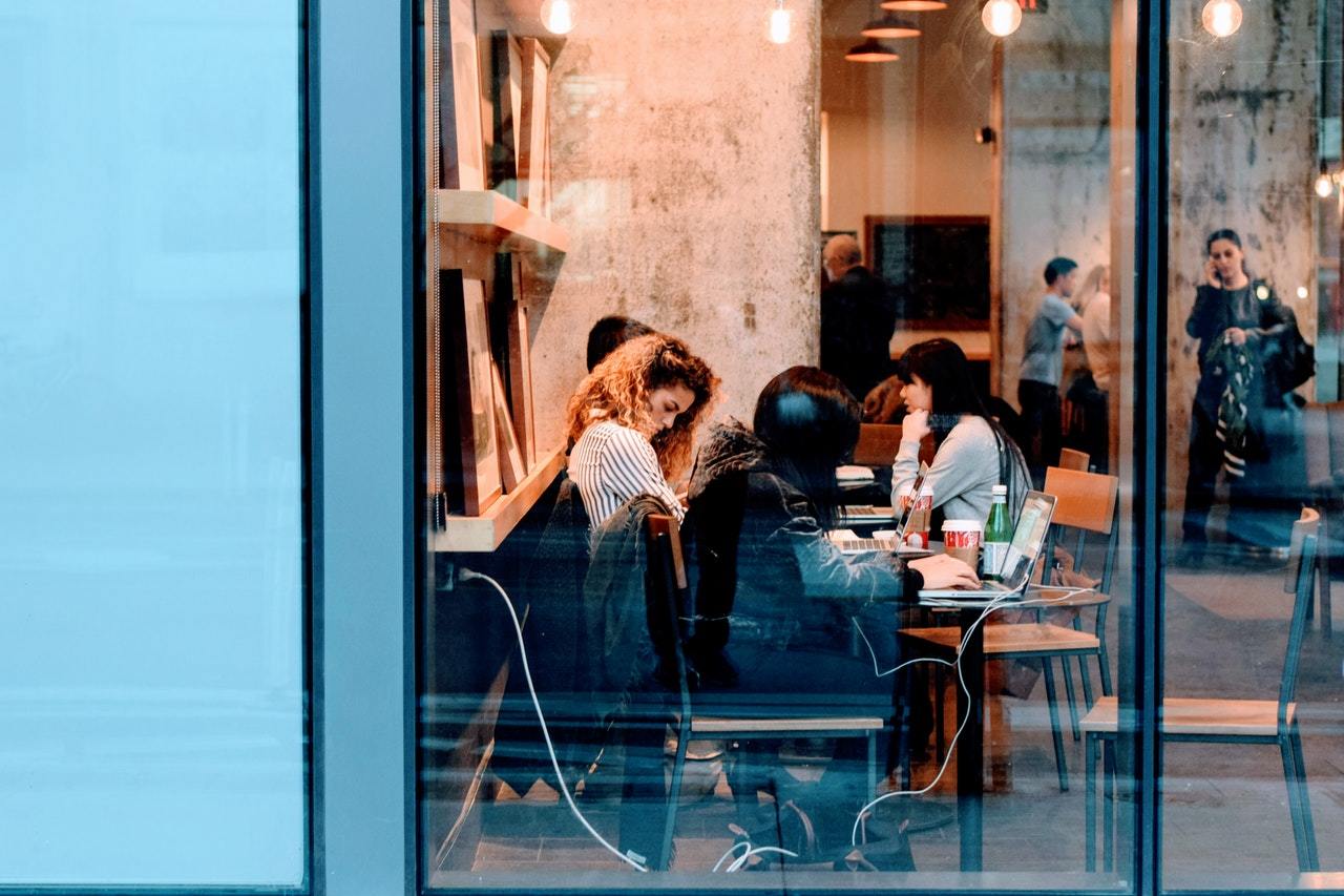 Group of people seen through a window of a cafe