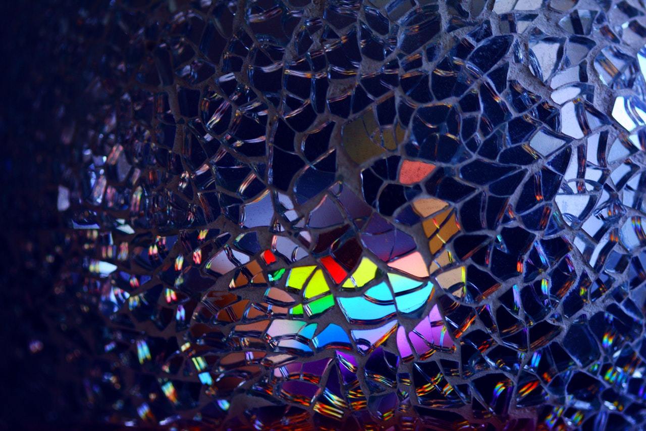Rainbow light on broken glass mosaic