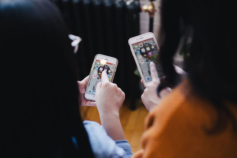 Two woman using smartphones