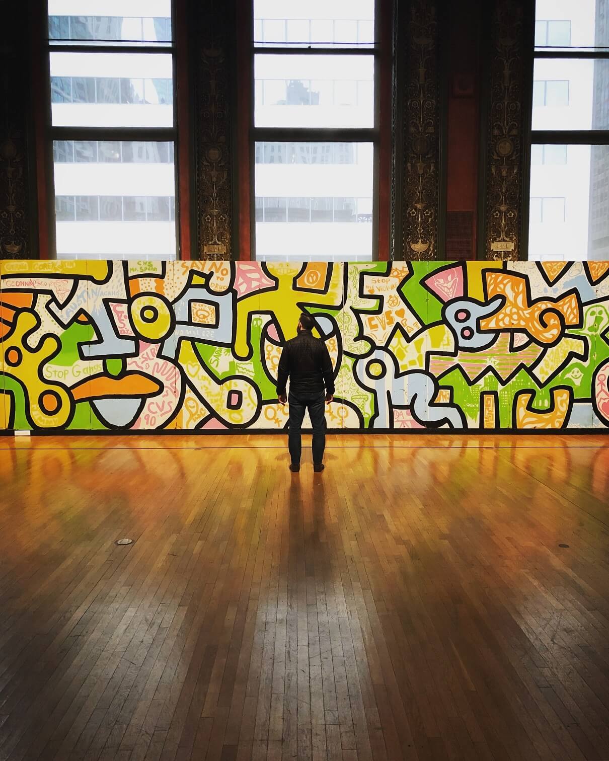 Man looking at a mural