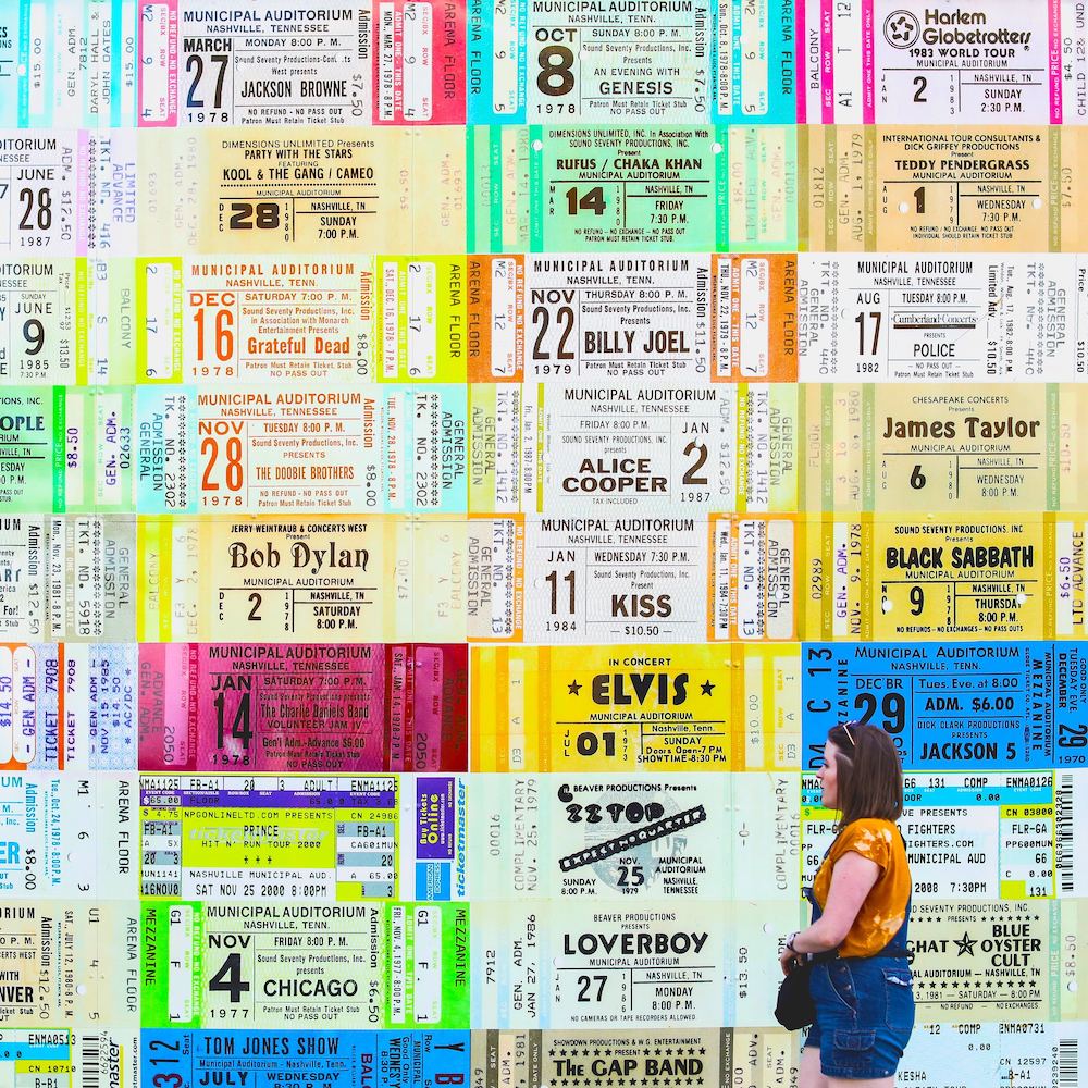 Wall installation of colourful concert tickets