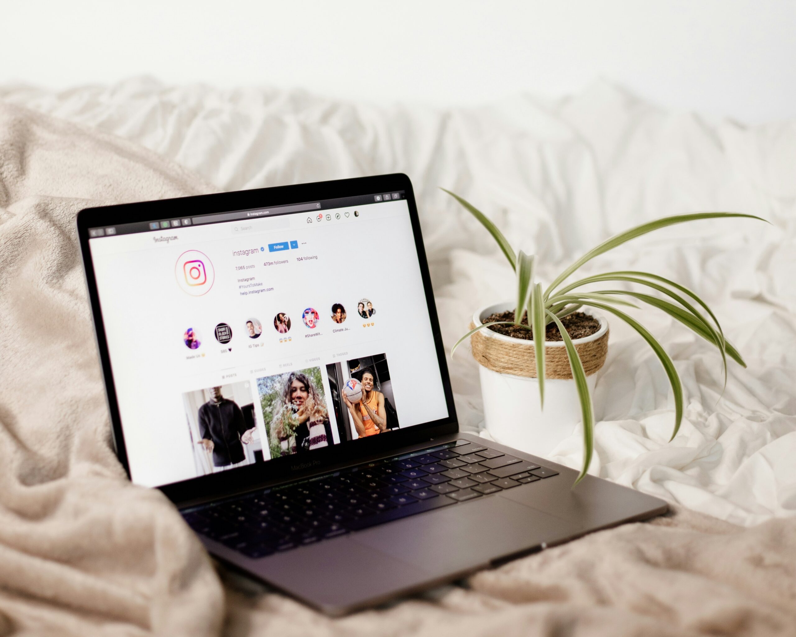 Laptop on a bed with Instagram on the screen