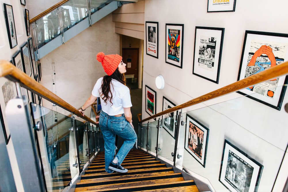 Women looking at art on stairs