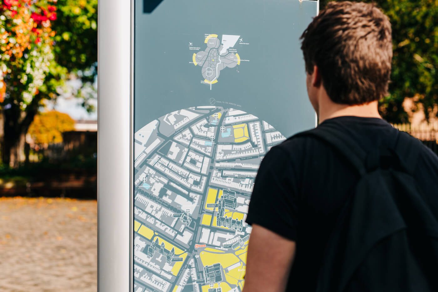 Back of man looking at map on street