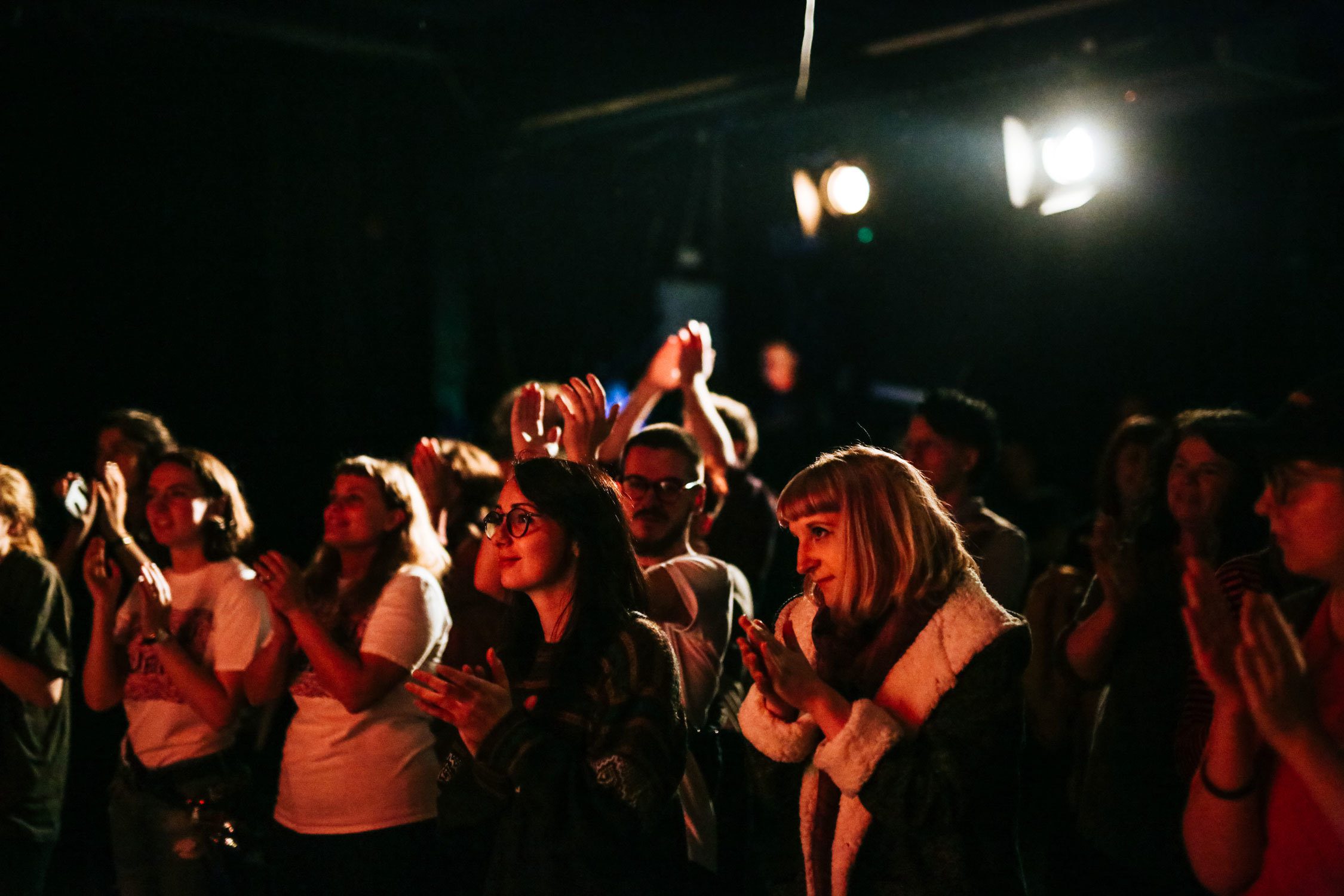 A crowd in a dimly lit venue